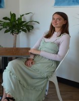 Rowan smiles while seated at a table